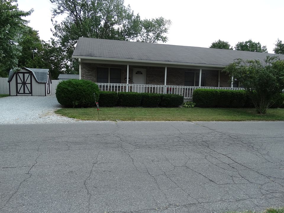 Front of House with Parking and storage building
