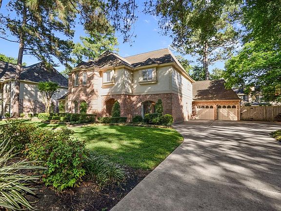 The perfectly landscaped yard with mature trees offers an immaculate curb appeal! The garage is a 2-car that is over sized with additional storage space on the left. Additionally, there is a door from the garage that goes out toward the backyard.