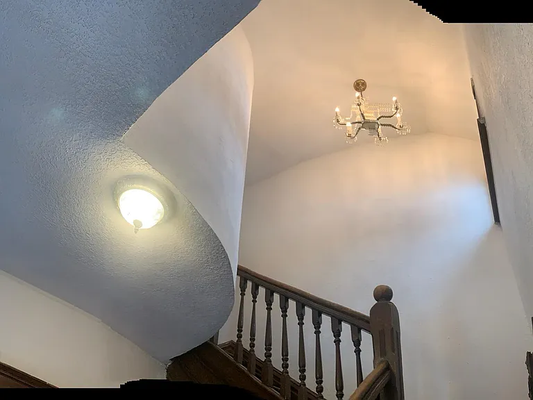 View of staircase chandelier from entrance
