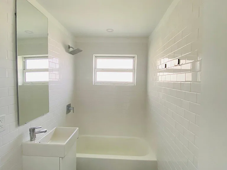 Subway tile from floor to ceiling, matte easy to clean floors.
