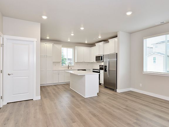 The living area seamlessly connects to the luxurious kitchen.