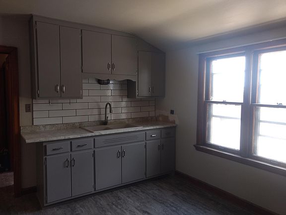 Kitchen - freshly painted cabinets - new countertop, floor, sink, lighting and backsplash