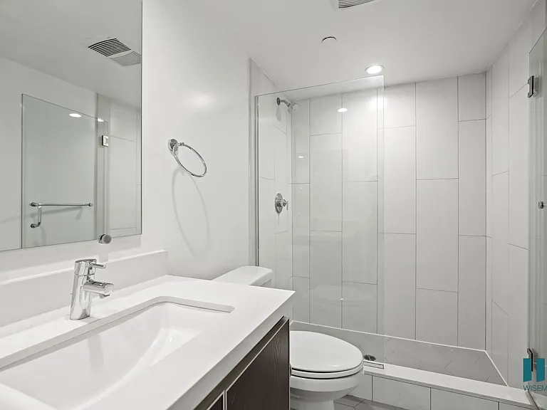 Bathroom with Walk-In Shower with Glass Door and Vanity Cabinet Storage