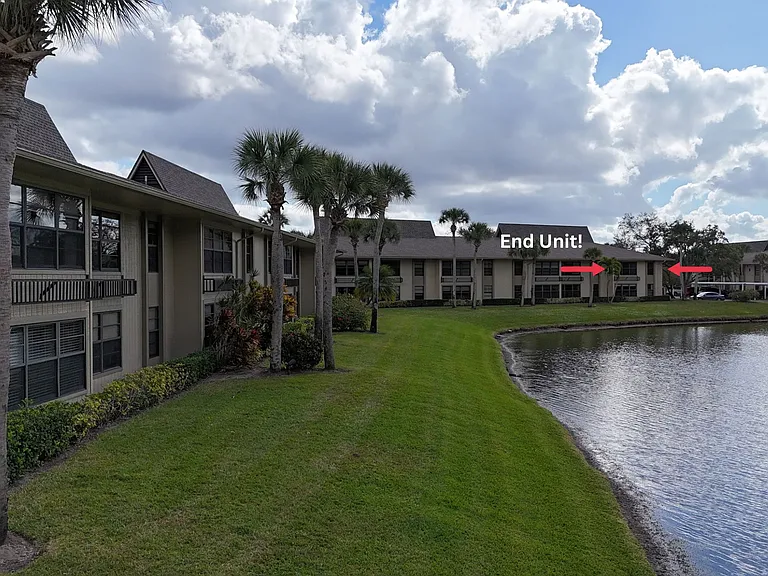 END UNIT w/ stunning expansive lake & golf course views!