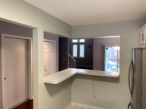 Breakfast bar looking out into the dining room and living room (Photo from earlier listing)