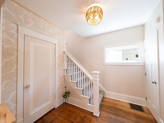 Entryway showing reclaimed Michigan wood and restored oak floors.