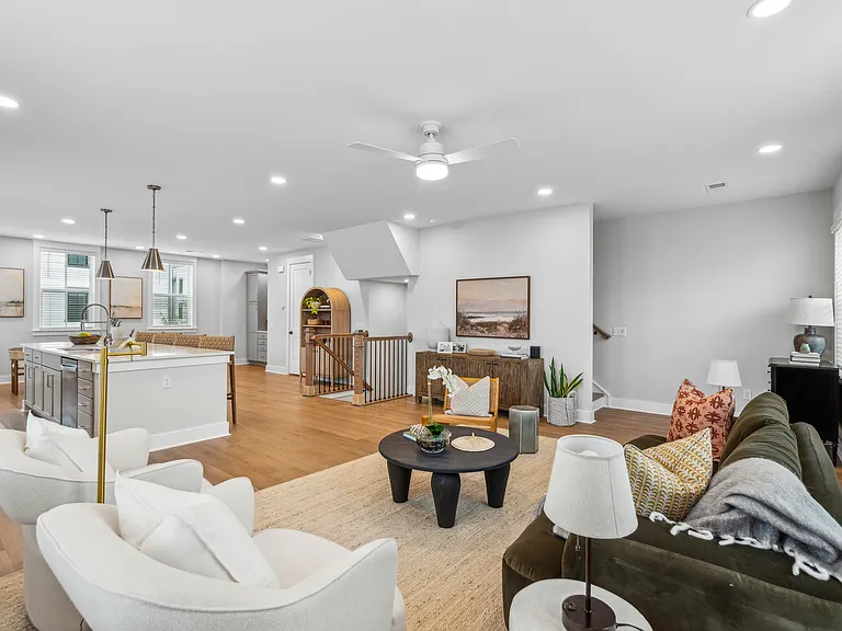 Spacious, flowing floor plan with living room, kitchen, dining, coffee station, and powder room