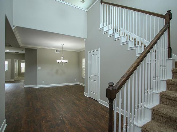 SUCH A PRETTY ENTRY HALL! THE TILE THAT LOOKS LIKE WOOD GIVES SUCH A WARMTH TO THE HOUSE.