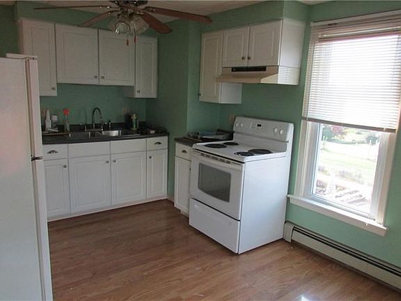 2nd floor kitchen with ceiling fan and appliances.