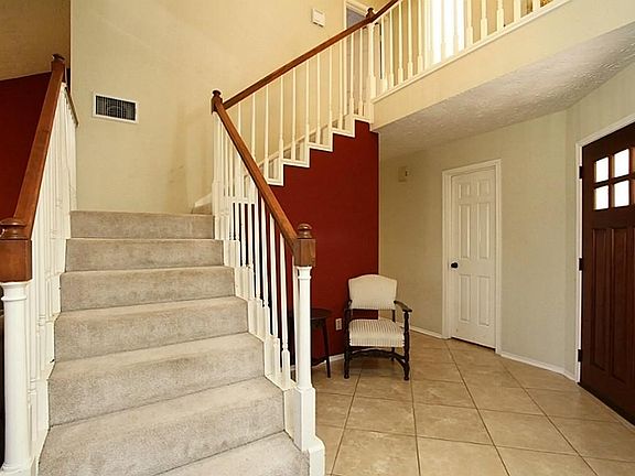 LUSH AND NEUTRAL CREAM CARPETING PROVIDES PATHWAY FROM FOYER/LIVING AREA TO UPPER LEVEL AND SECONDAR