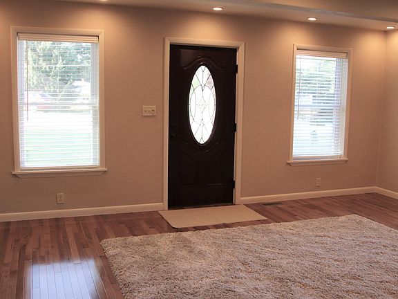 THE FRONT ENTRENCE. HARD WOOD FLOORS THROUGHOUT THE HOUSE.