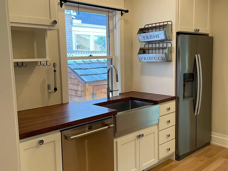 Kitchen - Stainless steel farmhouse sink, dishwasher, refrigerator. Extra deep butcher block counter tops.