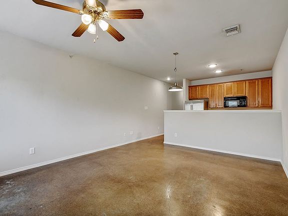 View from back door through living/dining room into kitchen