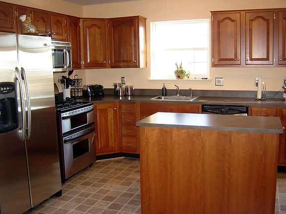 cherry kitchen with stainless appliances