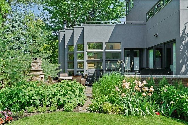 The owner redid the stucco exterior in a soft gray, which beautifully contrasts with the lush planti