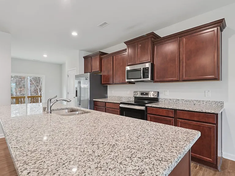 Classic Package Chef-inspired kitchen with stainless steel appliances and granite countertops