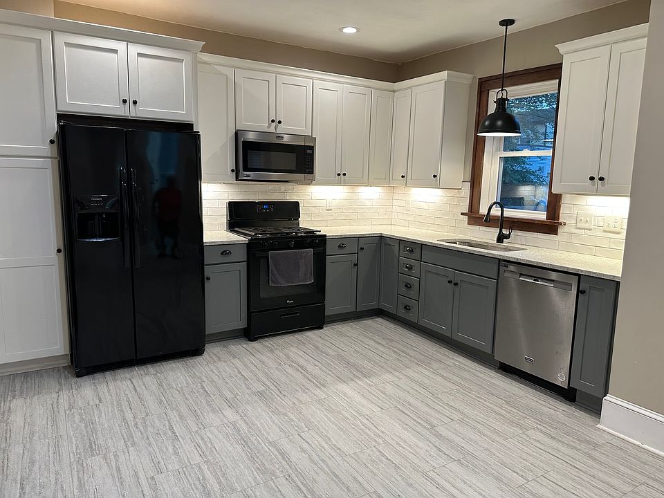 The kitchen is newly remodeled with a quartz countertop, new cabinets and a new floor. It's open, bright and faces south for tons of sunlight and cheery vibes!