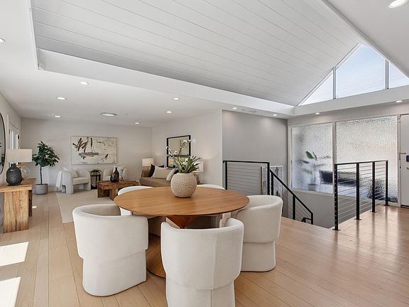 Open living room with tons of natural light coming from deck