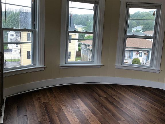 Curved wall in master bedroom with beautiful windows.