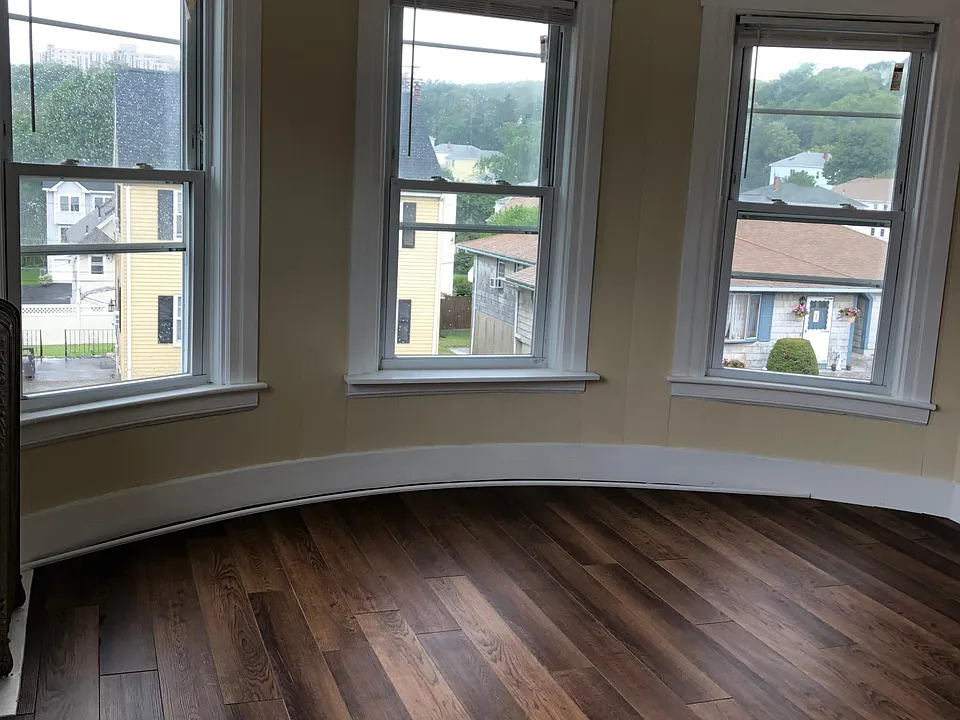 Curved wall in master bedroom with beautiful windows.