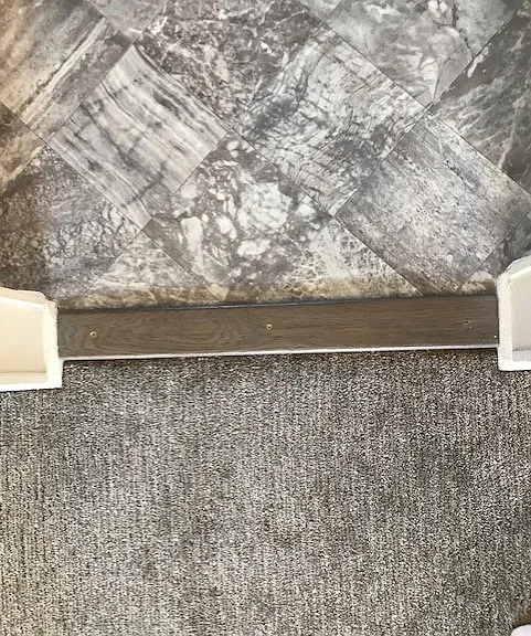 Kitchen flooring (above) very beautiful. Living room flooring (below) beautiful & luxurious. Lovely transition strip between.