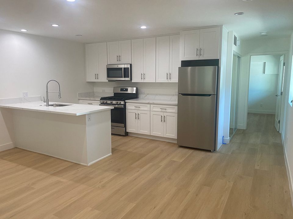 Gourmet kitchen with brand new stainless steel appliances including built in microwave, full dishwasher and refrigerator