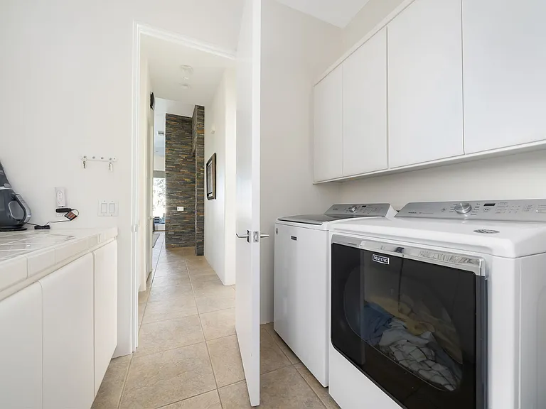 Laundry area with storage.