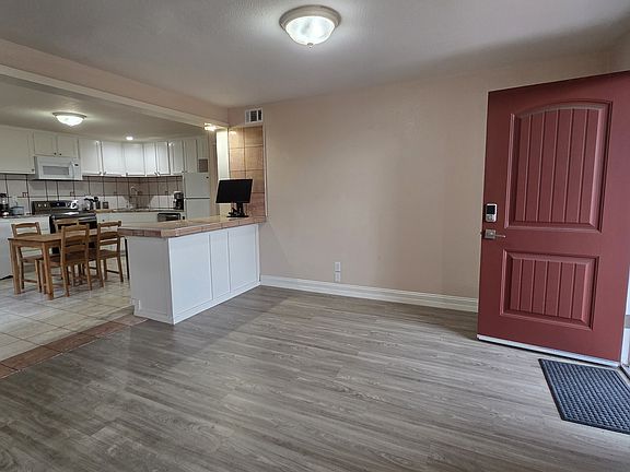 Living room, with view of the kitchen in the background