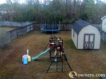 Fenced in back yard with barn