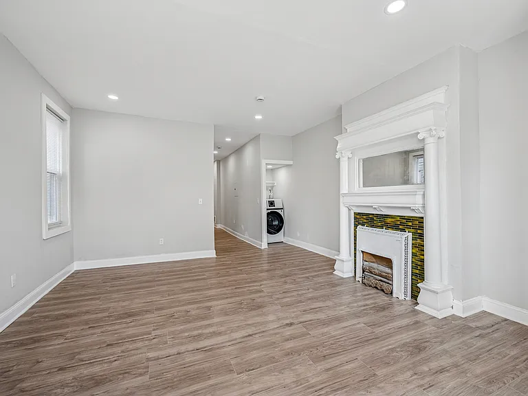 Spacious hallway, with lots of options for use, and a tucked-away laundry area