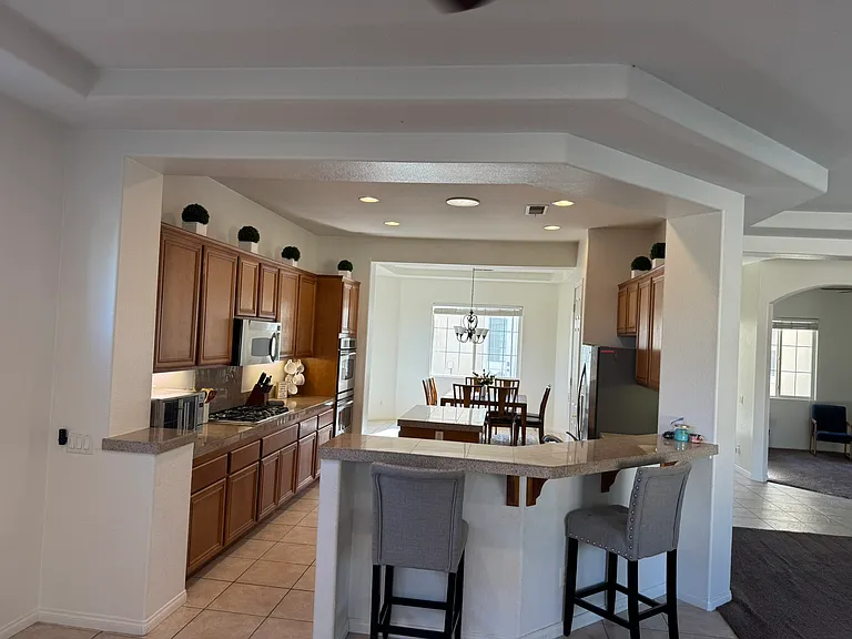 View of kitchen from open area off of living room