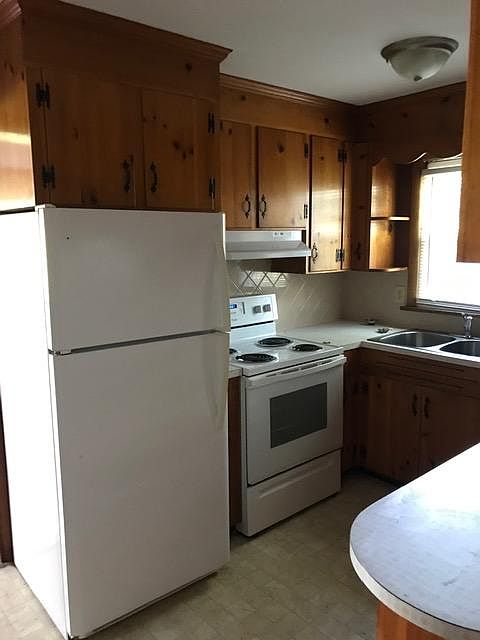 Kitchen view. Electric appliances. New vent hood. Good storage. Counter on right view above opens to dining area.