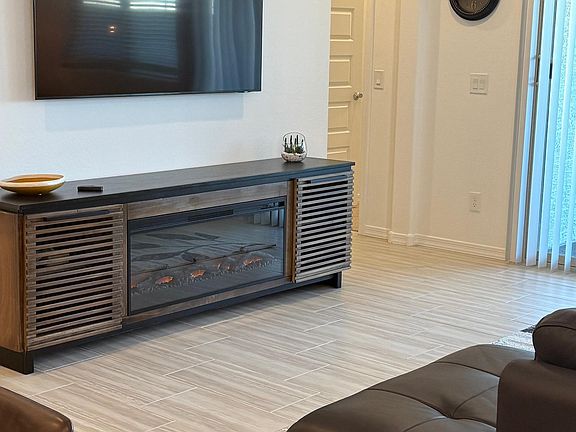 65 inch smart tv in living room and fireplace for the cooler months