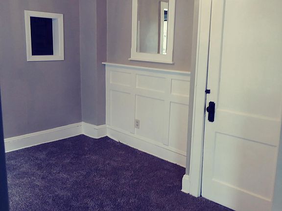 Living room has a mirror accents and an access to kitchen.