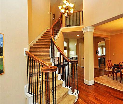 Curved staircase with iron banister. Stunning view from 2nd floor.