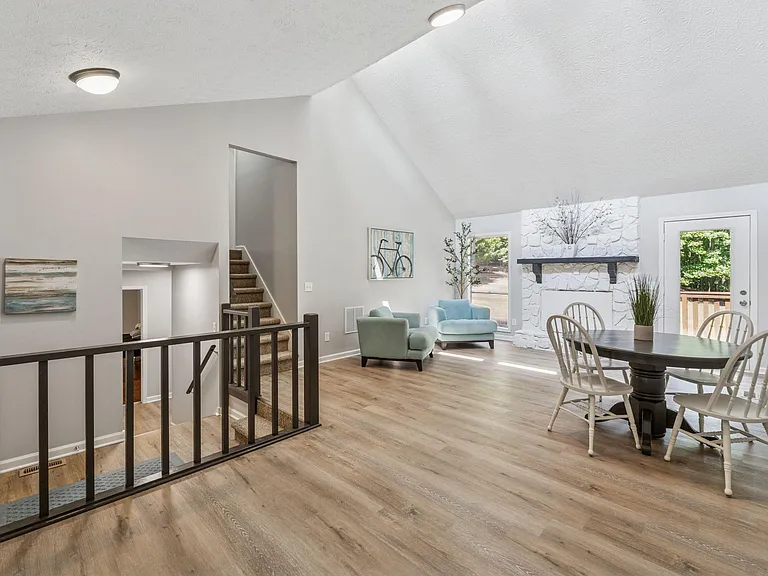 Spacious living area showing stairs going up.