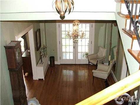 Elegant 11' x 21' entry hall with original crystal chandeliers
