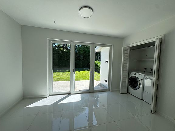 View of the back patio, backyard, laundry and open area for dining.