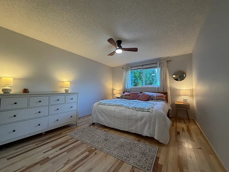 Bright and comfortable primary bedroom, with brand new mini split heat/air conditioner. Mattress is new and covered in high-tech mattress cover, on solid wood king bedframe. Furniture, including dresser, included in rental.