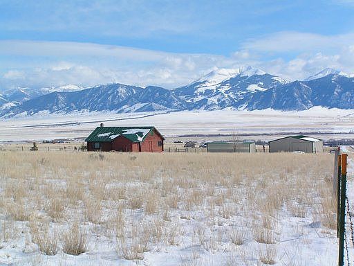 Winter view with view of Madison Range and outbuildings