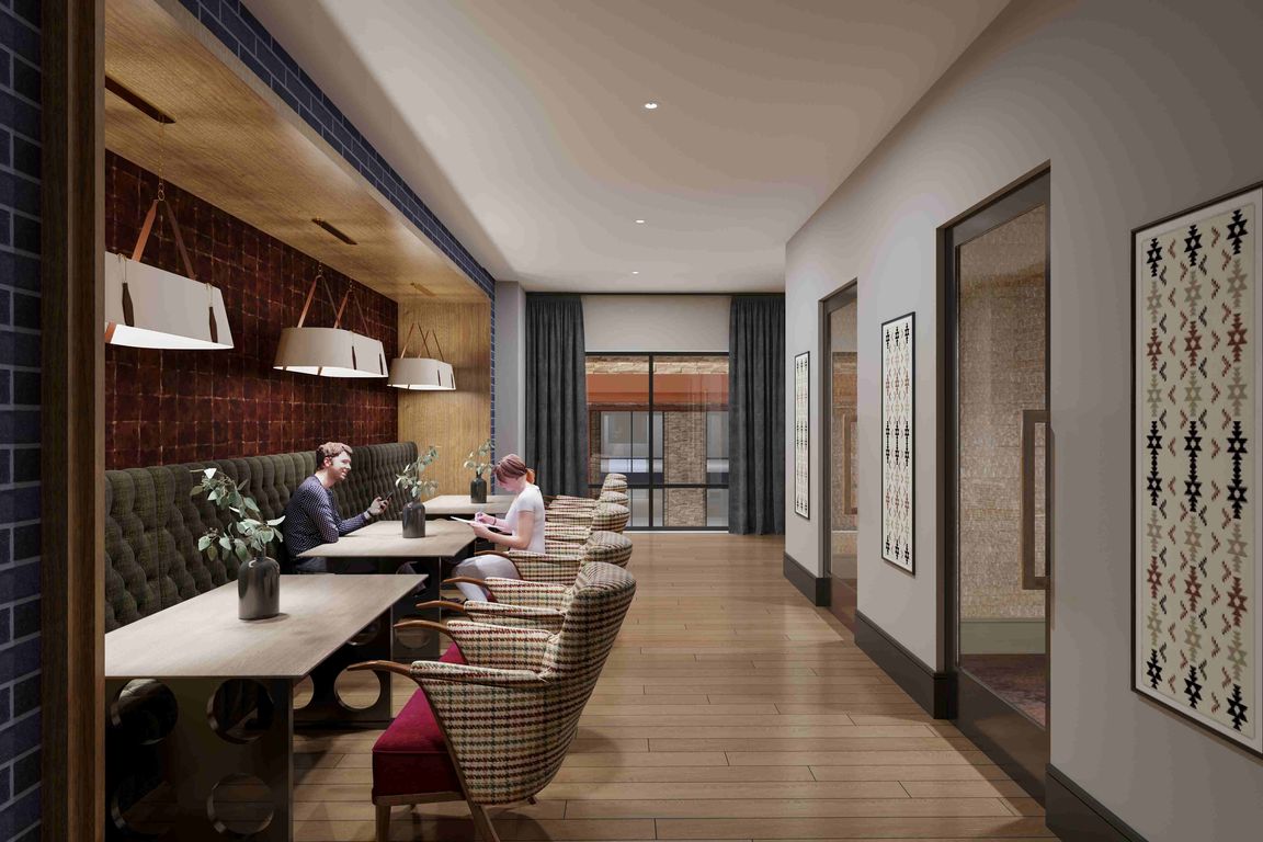 A flexible business lounge offering collaborative seating, vibrant artwork, and a polished environment for work or study.