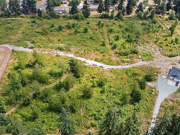 Overhead showing parcel from west side of parcel that is between fence on the left and home on the right