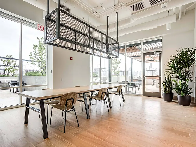 Gather around the dining table in the sunlit lounge, where natural light brightens the space for a comfortable and relaxed atmosphere.