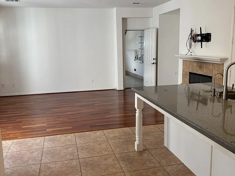 kitchen island counter view to family room and entry to garage
