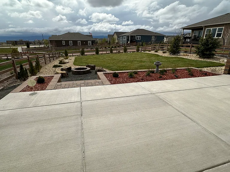 Extended patio, flower garden, and fire pit