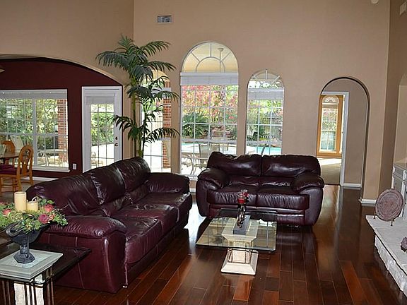 Large Family Room, High Ceilings, Wall of Windows overlook Large Covered Patio & Pool