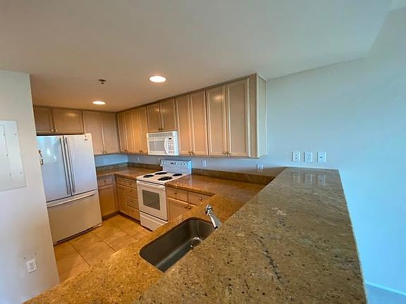 Kitchen with granite countertop and maple cabinets