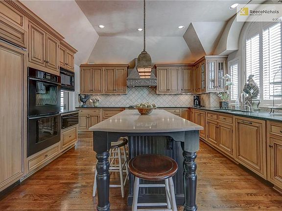 Custom cabinetry, SubZero built in fridge, refrigerated drawers in island and granite counters.