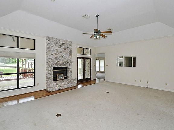 ANOTHER VIEW OF THE LIVING ROOM AS IT LEADS INTO THE DEN KITCHEN AREA.
