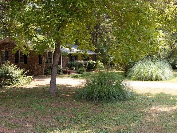 Large front yard with pretty landscaping